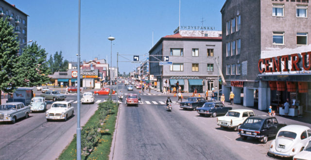 Kauppalankatua 1970-luvun alussa, autoja parkissa ja kadulla, Centrumin tavaratalo oikealla ja Kääriäisen talo taustalla